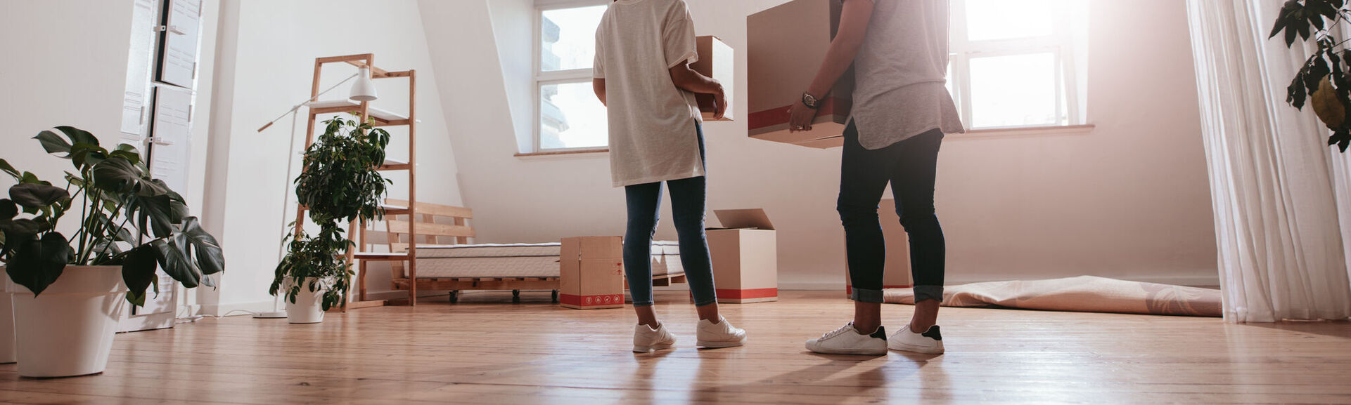 Couple in empty room with boxes 