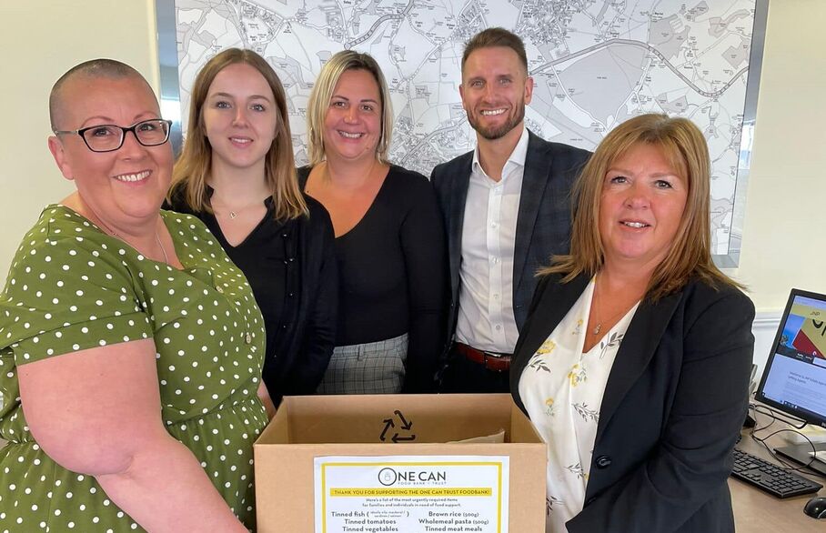 A group of JNP employees holding a donation box