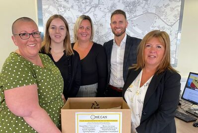 A group of JNP employees holding a donation box