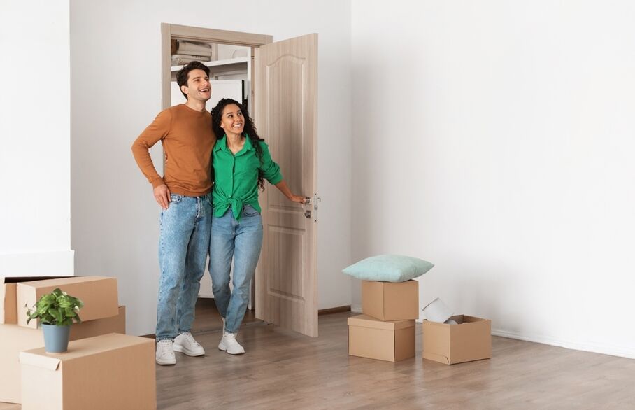 Two people looking around a room full of boxse