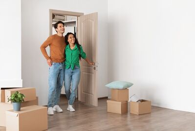 Two people looking around a room full of boxse