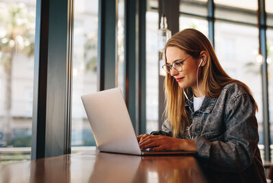 Someone looking at a laptop