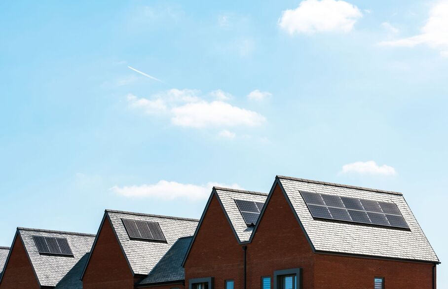 The rooves of houses with solar panels on