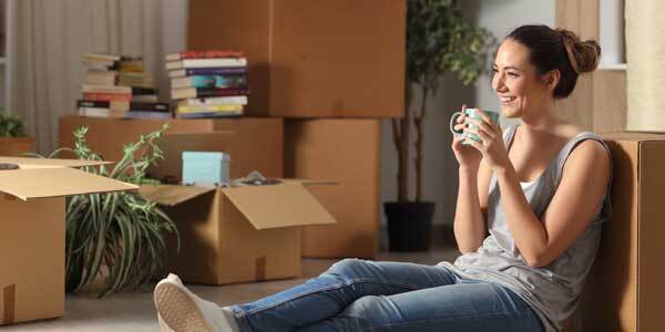 Woman sat in new home with boxes