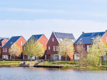 A row of houses in front of a body of water