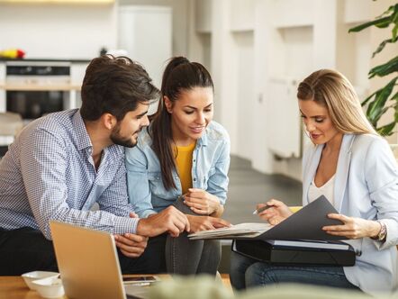 A couple sitting with an estate agents